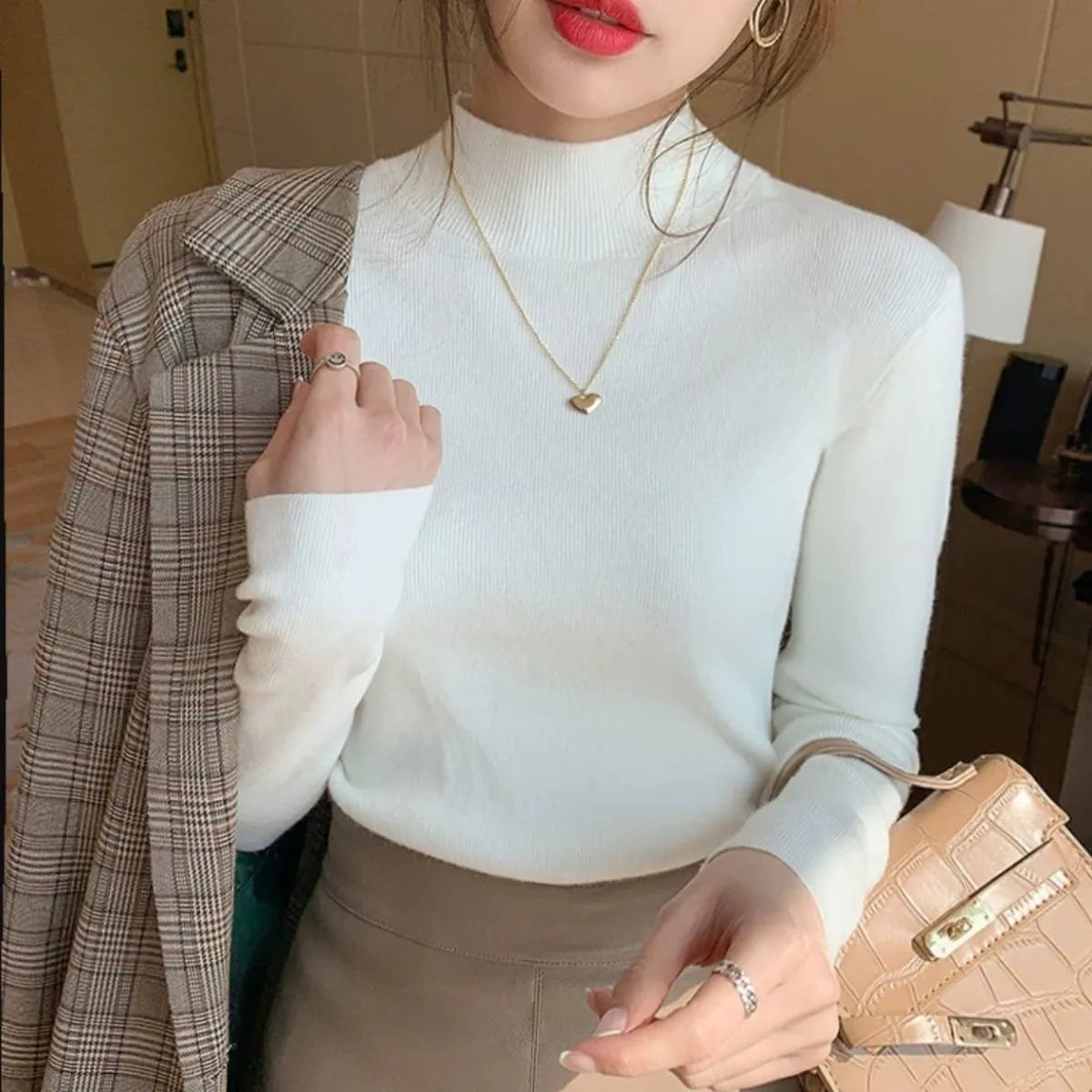 Slim fit knitted viscose bottoming shirt in a neutral colour with long sleeves, shown on a hanger.