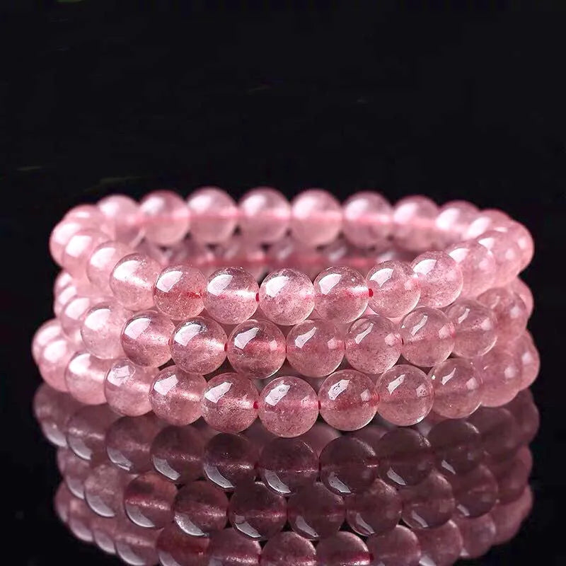 Women's strawberry quartz crystal bracelet with polished beads in 6mm, 8mm, and 10mm size options.