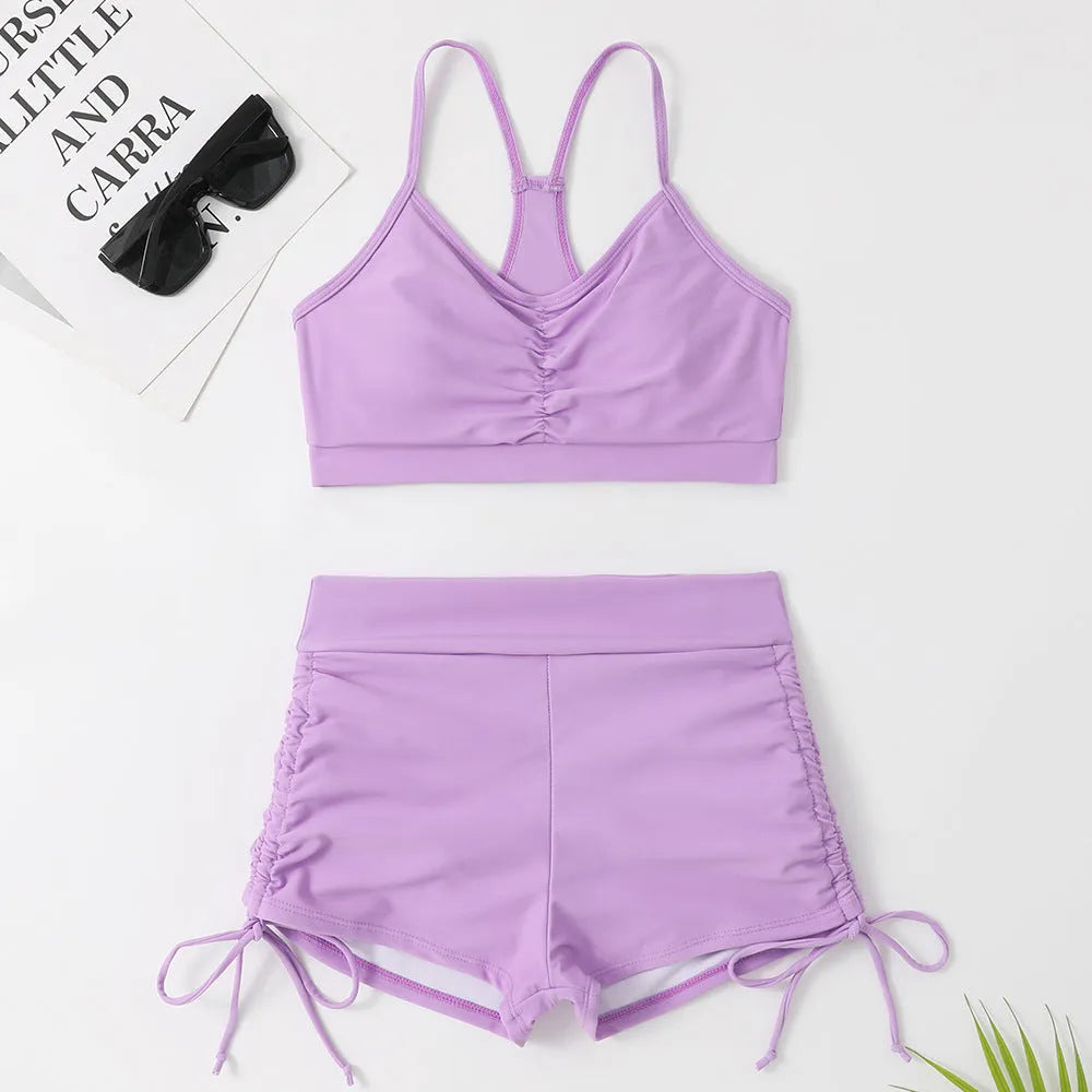 Purple women's high waisted bikini swimsuit with split side shorts and matching top
