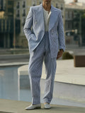 Blue and white striped polyester suit set with blazer and trousers on hanger