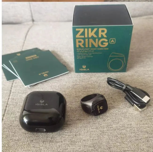 Zikr1 metal smart ring with OLED display showing prayer count, worn on a finger.