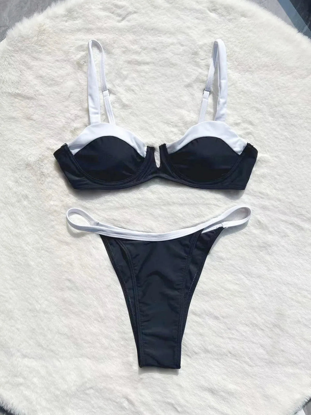 Black women's low waist bikini with stitching split detail on briefs, shown from front.