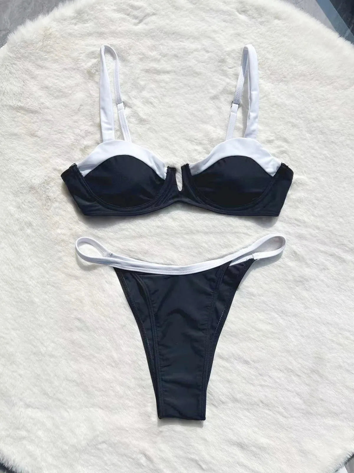 Black women's low waist bikini with stitching split detail on briefs, shown from front.