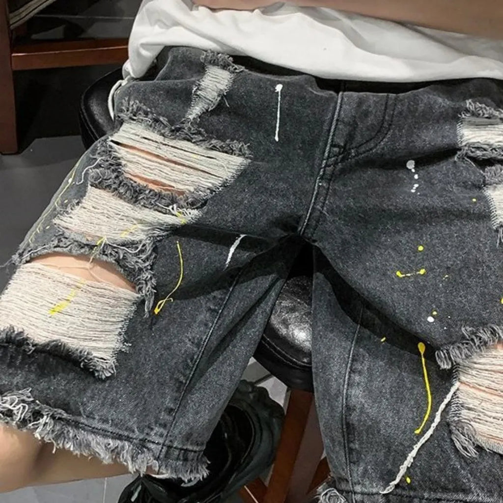 Men's loose fit denim shorts with water-washed hole design in black cotton blend fabric