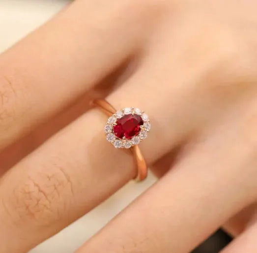 Sterling silver ring with gold pigeon design and red gemstone in floral pattern