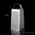 Multifunctional stainless steel vertical grater with cylindrical handle on a kitchen counter