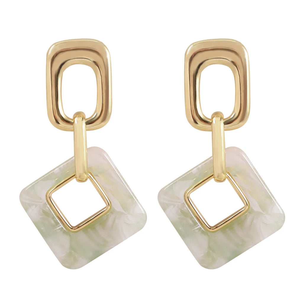 A pair of hollow geometric square earrings with chamfered corners, made from electroplated copper.