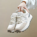 Women's black platform casual shoes with round toe and front lace-up design on a neutral background.