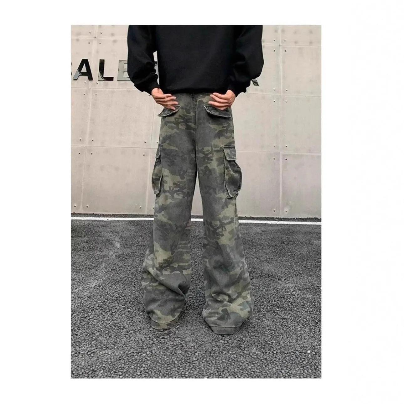 A pair of washed camouflage cotton blend cargo trousers with multiple pockets on a mannequin.