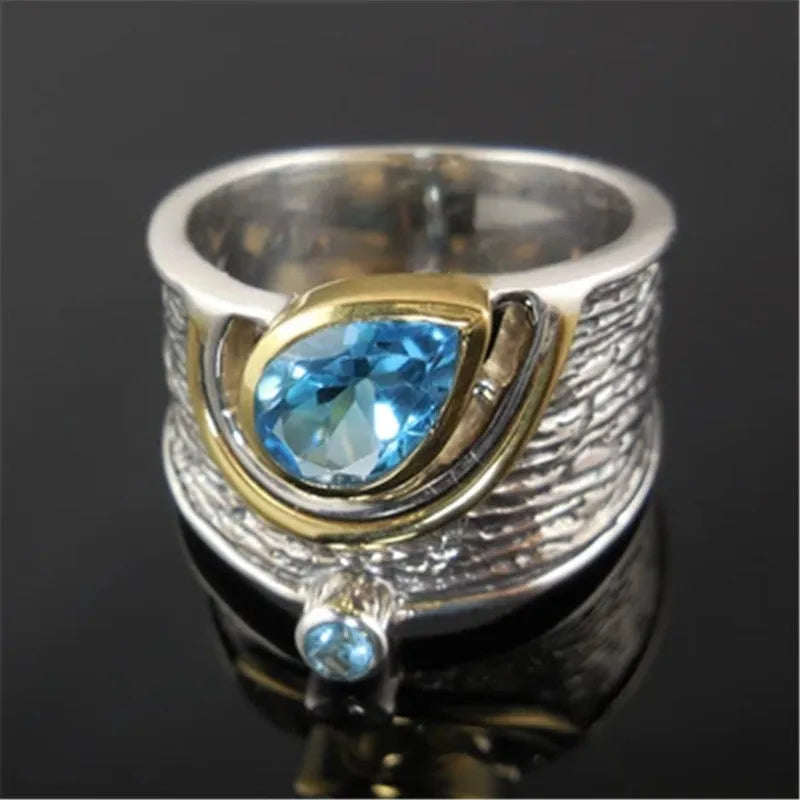 Blue zircon drop shape ring with Chinese-inspired design in alloy setting