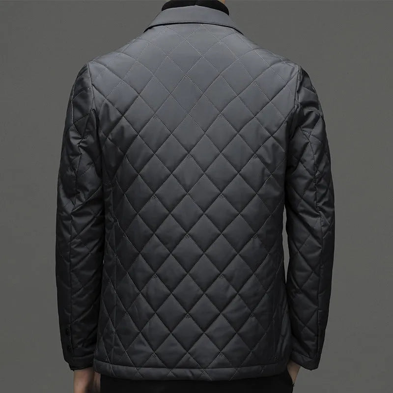 A man wearing a solid-colour thick down jacket with a lapel and side seam pockets.