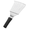 Stainless steel dematting brush rake comb for dog and horse grooming on a table.
