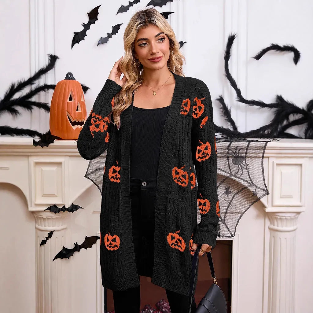 Women's black Halloween cardigan with orange pumpkin head jacquard knit pattern, shown open.