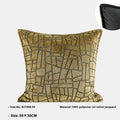 Gold geometric pattern decorative cushion cover on a grey sofa