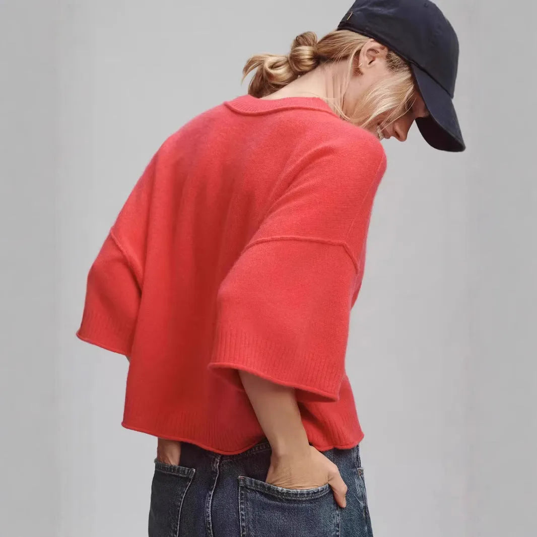 Red cropped t-shirt on a hanger, showing midriff length and regular sleeves.