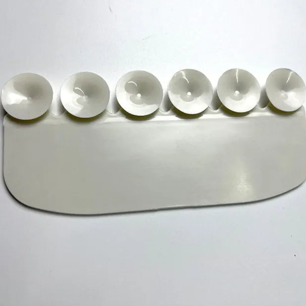 White PVC urine blocking board for children's toilet training placed on toilet