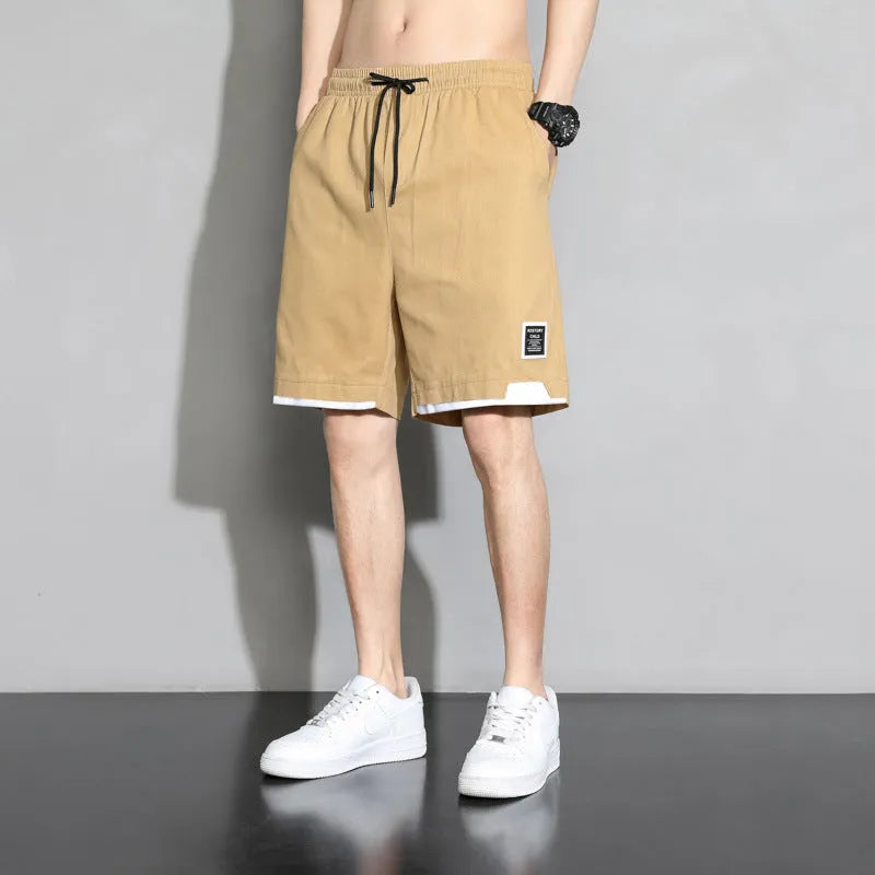 Boys' black cotton shorts in a plus size on a hanger