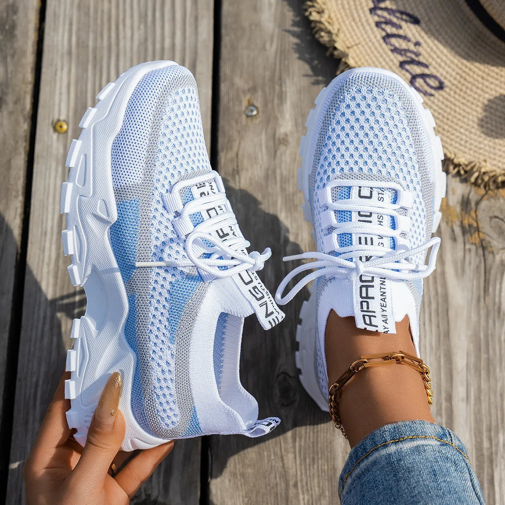 Women's low heel Flyknit mesh sneakers in a grey colour scheme with lace-up front.