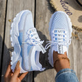 Women's low heel Flyknit mesh sneakers in a grey colour scheme with lace-up front.