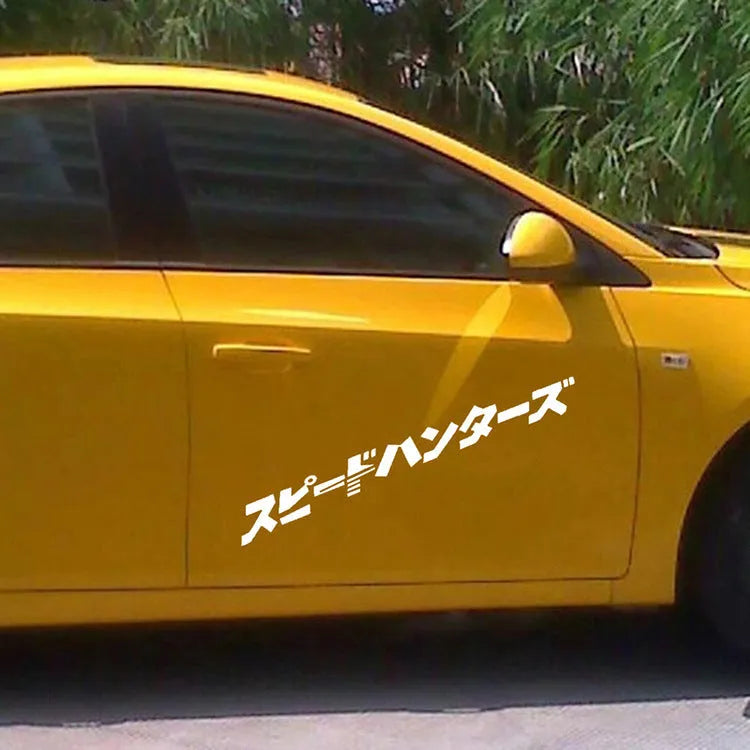 Black and white 35x35cm square reflective Japanese car sticker on a vehicle window.