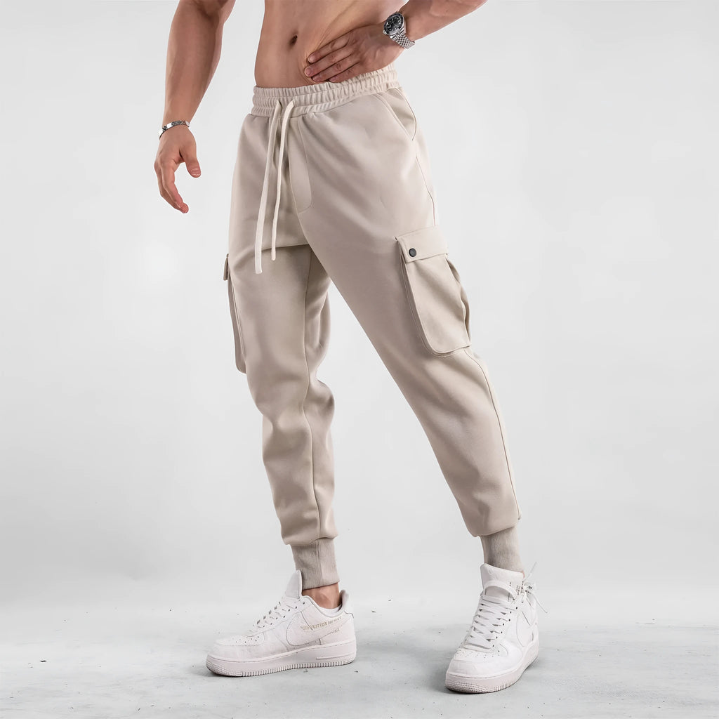 Men's loose cotton trousers with ankle ties in apricot colour showing multi-pocket design