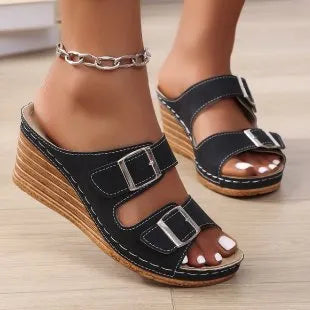 Women's creamy white beach slippers with a silver buckle on the strap