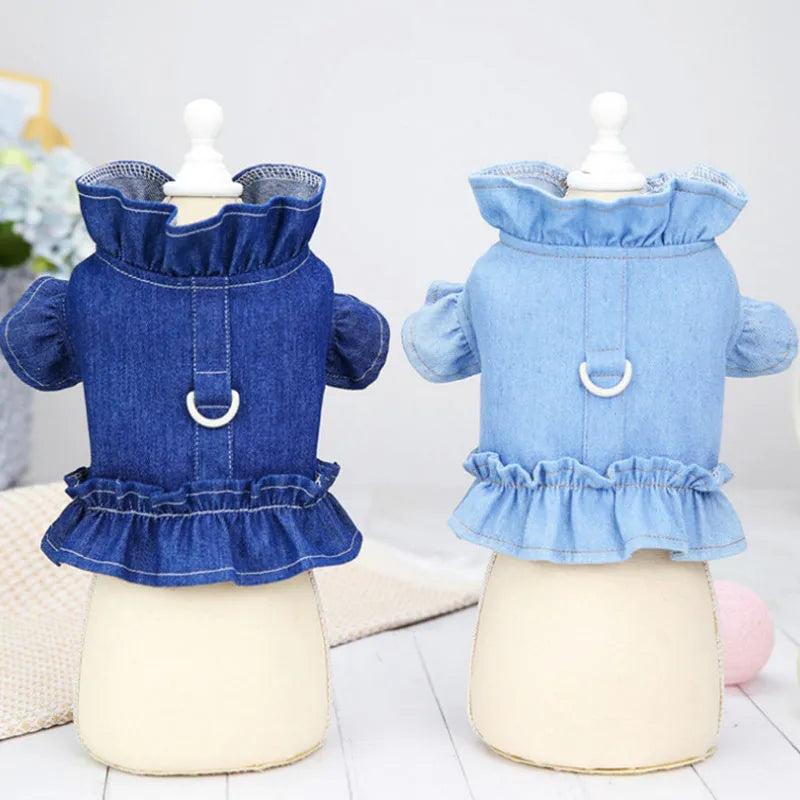 Blue denim dog dress with ruffles and a chest harness leash hook on a mannequin.