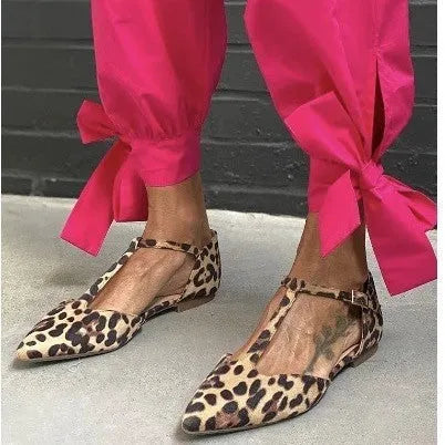 Leopard print women's pumps with a pointed toe and a low chunky heel on a rubber sole.