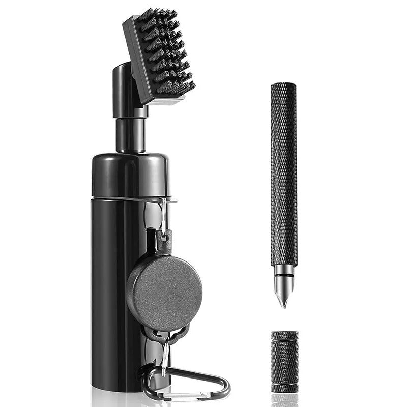 Black plastic golf club groove cleaning tool on a grassy surface with a golf ball nearby