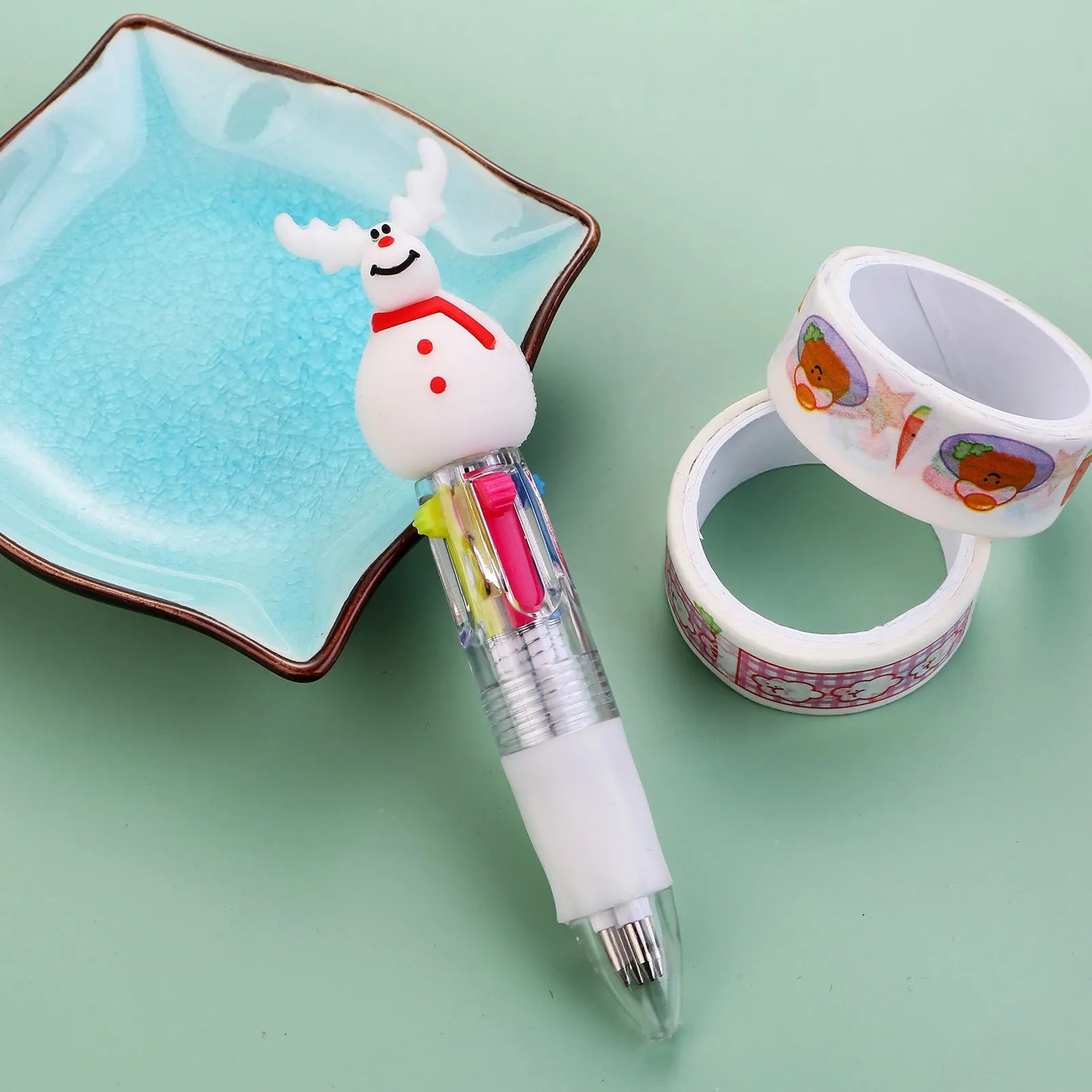Christmas mini four-colour press-action ballpoint pen with festive designs measuring 11 cm.