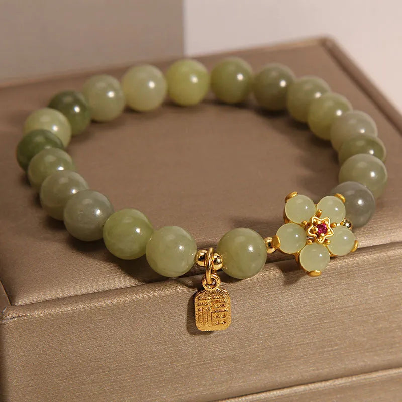 A grey jade and alloy casual bracelet for women, showing its unique design.