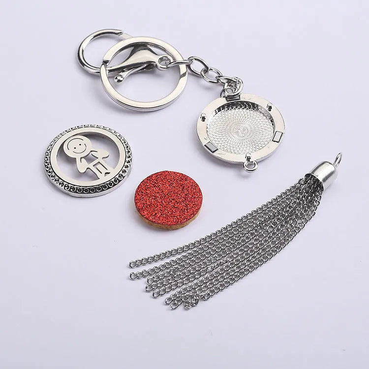Alloy tassel car pendant with chain hanging, showing 12mm diameter fragrance compartment and coloured cotton inserts