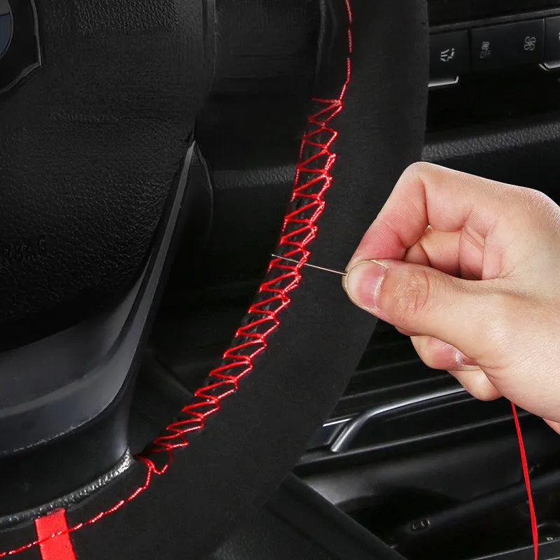 Black and red suede steering wheel cover fitted on a 38cm diameter car wheel.