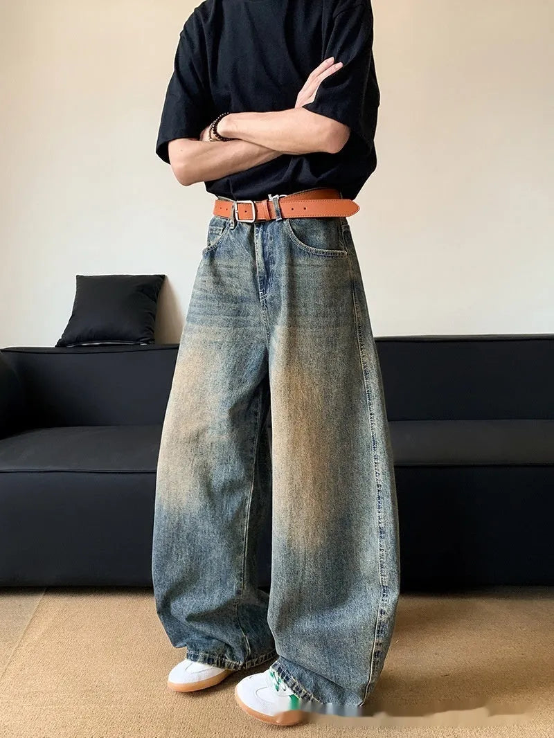 Men's retro blue distressed denim jeans with a wide-leg slim fit and micro elasticity.