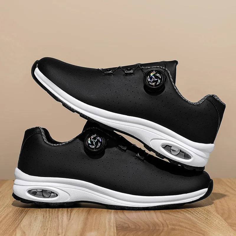 Black and white low-top casual tennis shoes with mesh upper, cross shoulder straps, and flat composite sole.
