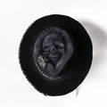 Handmade wool Halloween skull hat with a conical crown on a denim hat base.