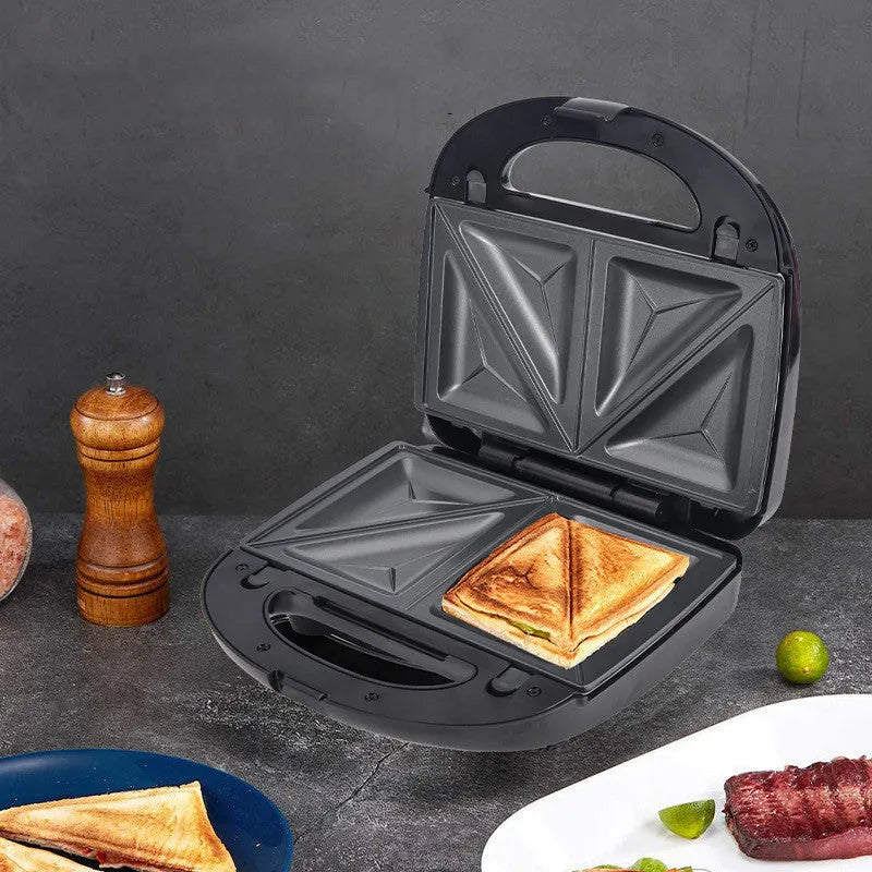 Black double-sided electric sandwich pan with brushed stainless steel lid and non-stick coating.