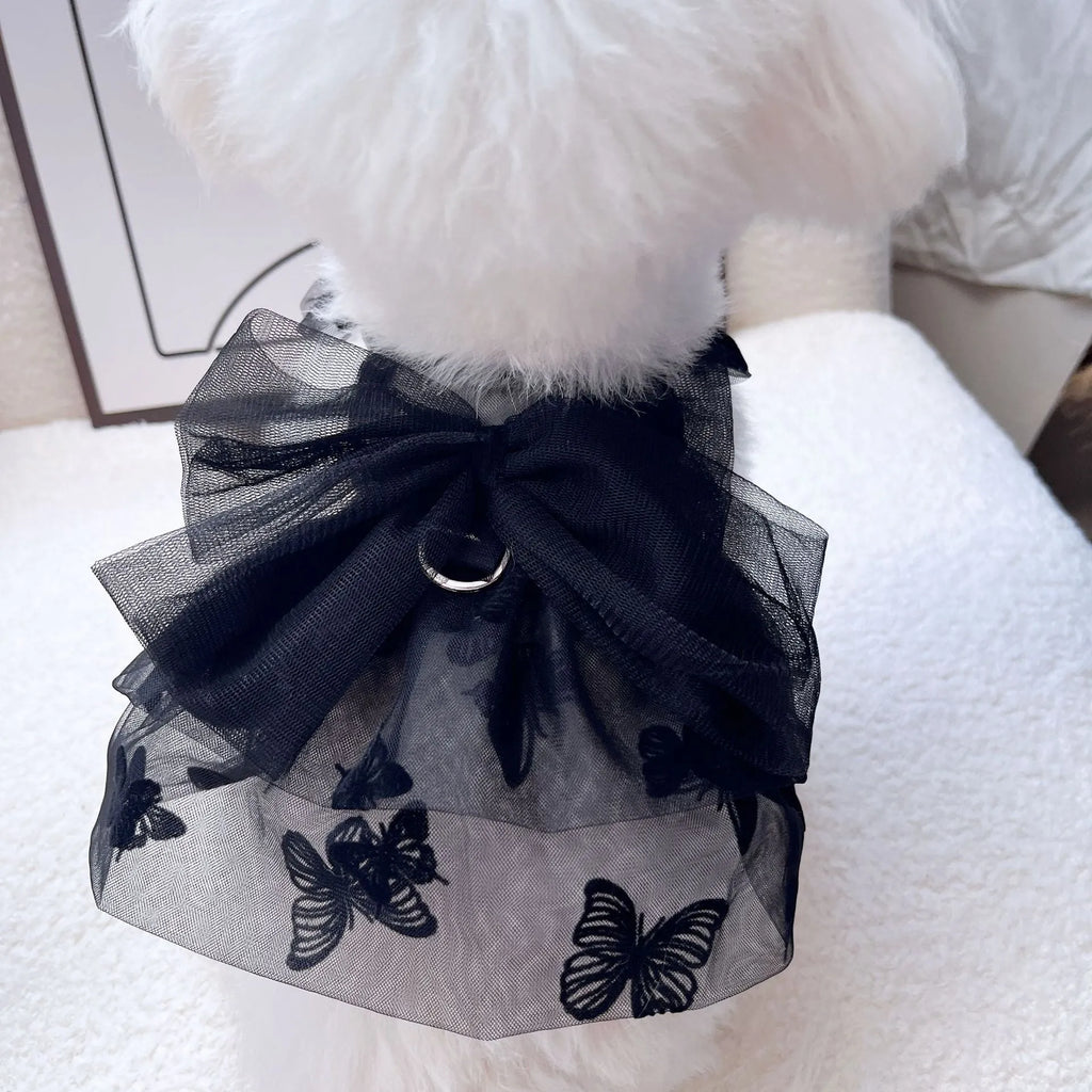 Black polyester tulle princess skirt for a small dog or cat on a hanger.