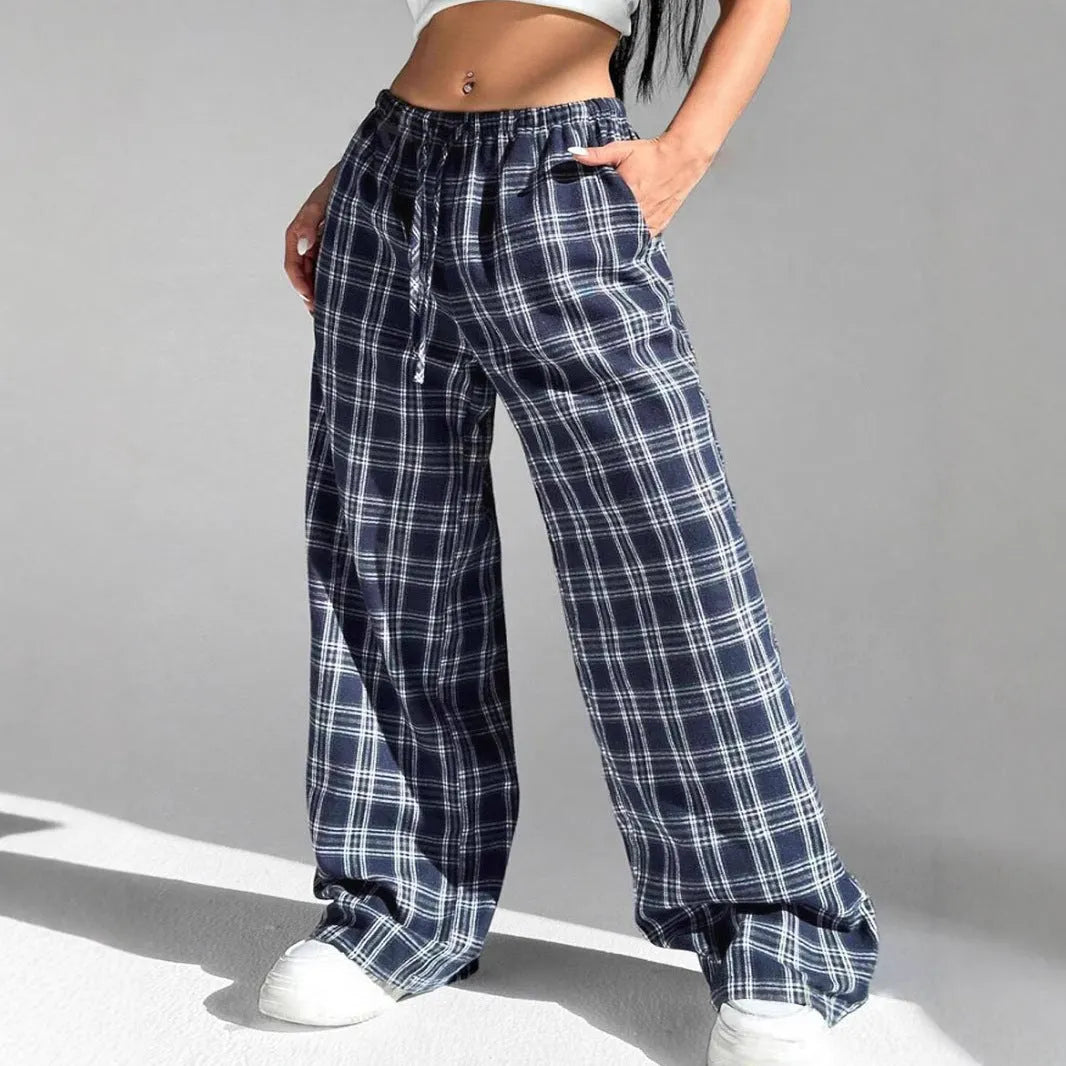 Women's red loose fit casual trousers with drawstring waist and plaid pockets, laid flat.