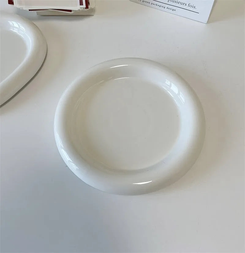White ceramic plate with black hand-drawn doodle design, shown in bear and round patterns.