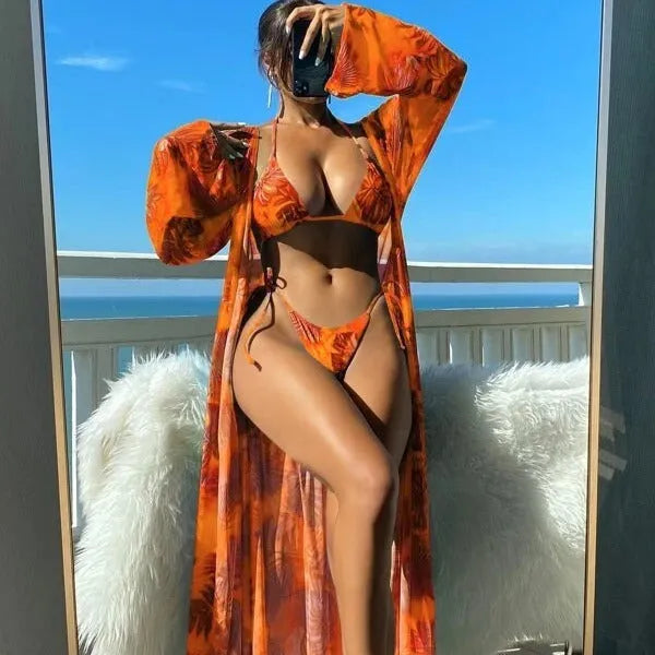 Women's floral pattern bikini set with long sleeve cover-up and banded briefs on a mannequin