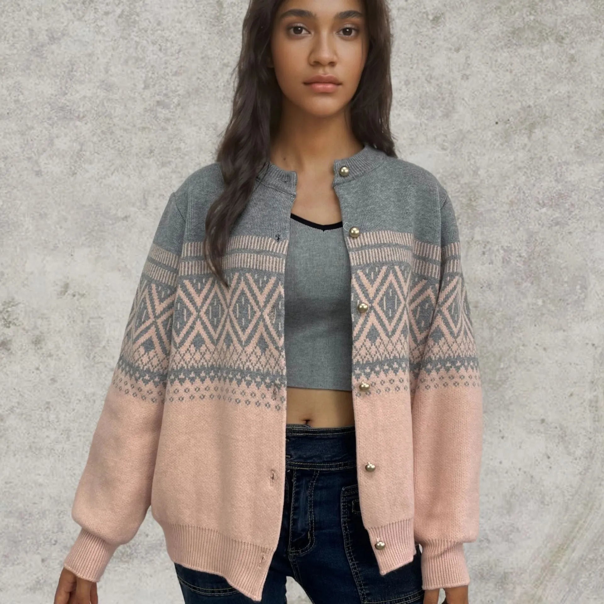 Women's grey alpaca wool cardigan with a red and white diamond knit pattern and long sleeves.