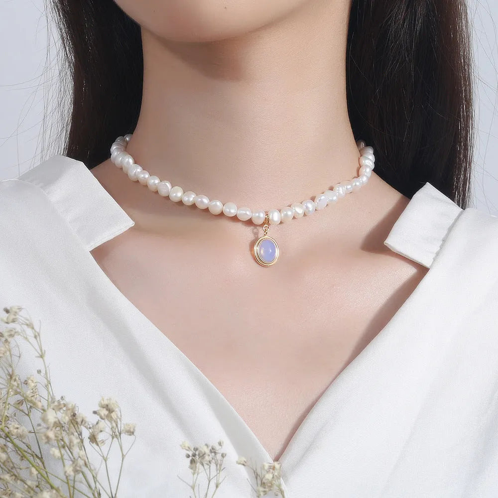Silver necklace with geometric pendant and irregular pearls on adjustable chain
