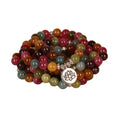 Multi-layer beaded bracelet with 108 tourmaline beads, lotus charm, and alloy clasp on a wrist.