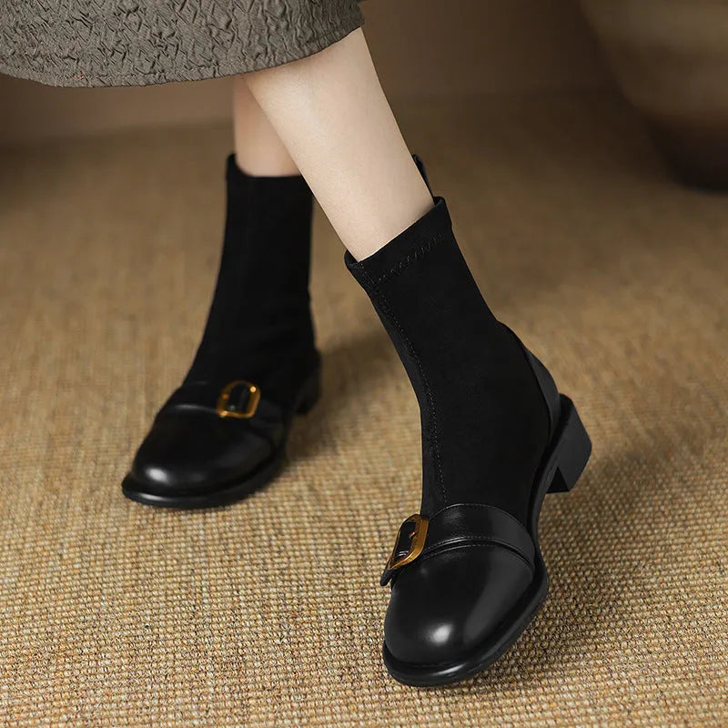 Black women's low heel Martin boots with front lace-up and decorative belt buckle stitching on a round toe.