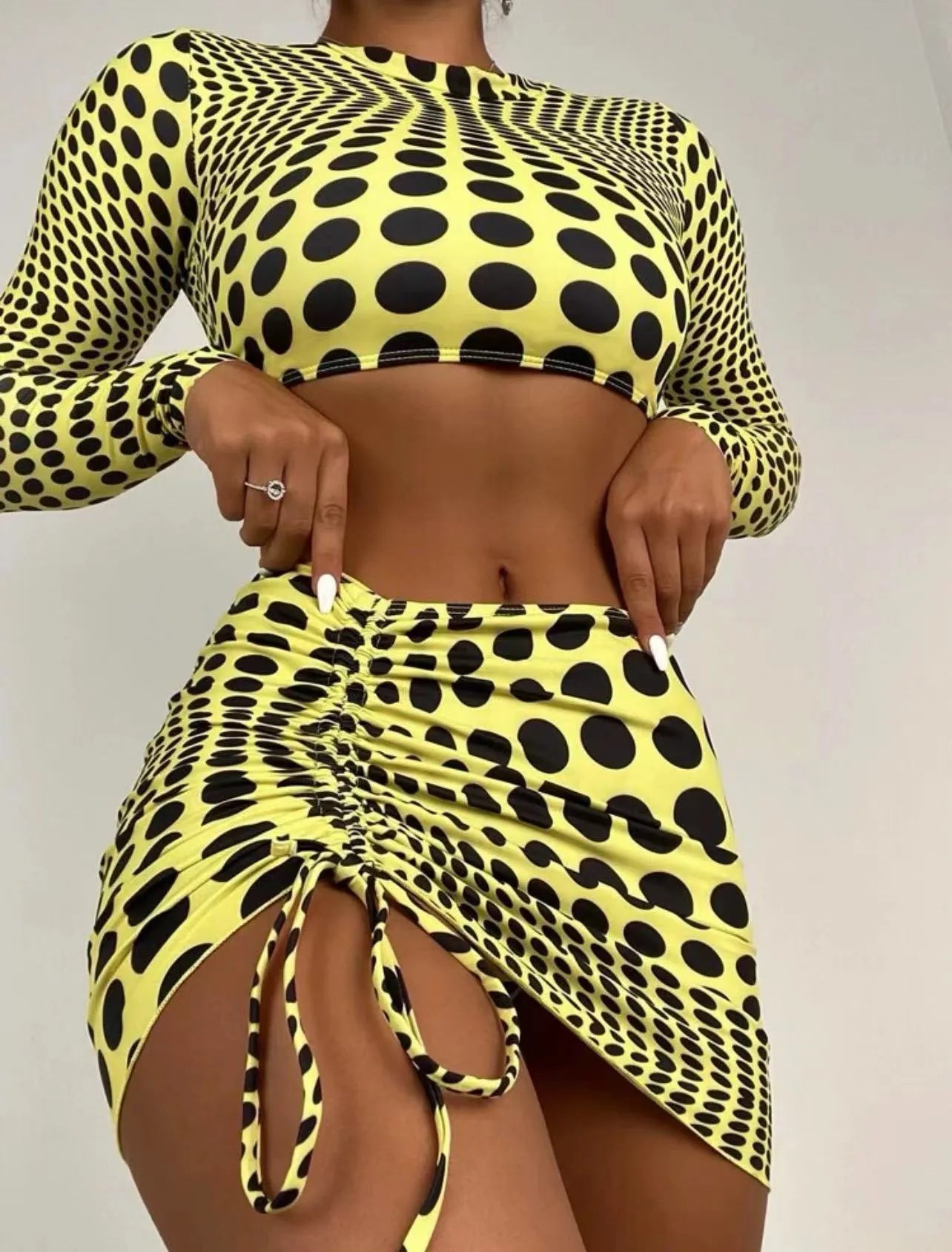 Women's green polka dot swimsuit three-piece set showing halterneck top and skirt