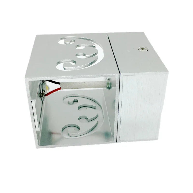 Modern silver aluminium butterfly-shaped LED wall lamp with remote control for changing light colours.