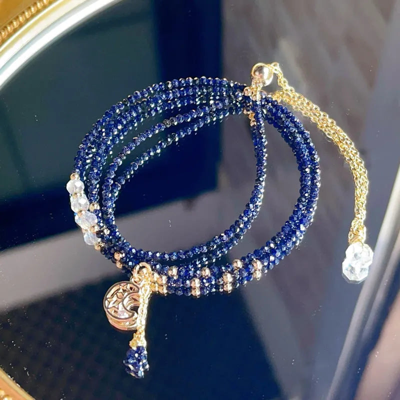 Close-up of a blue sandstone and gold multi-layer three-ring bracelet for women.
