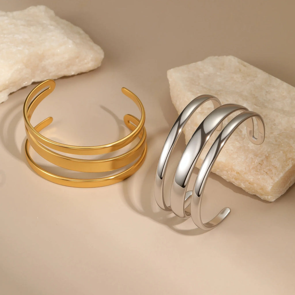 Women's stainless steel geometric bracelet with simple opening in gold or steel electroplated finish.