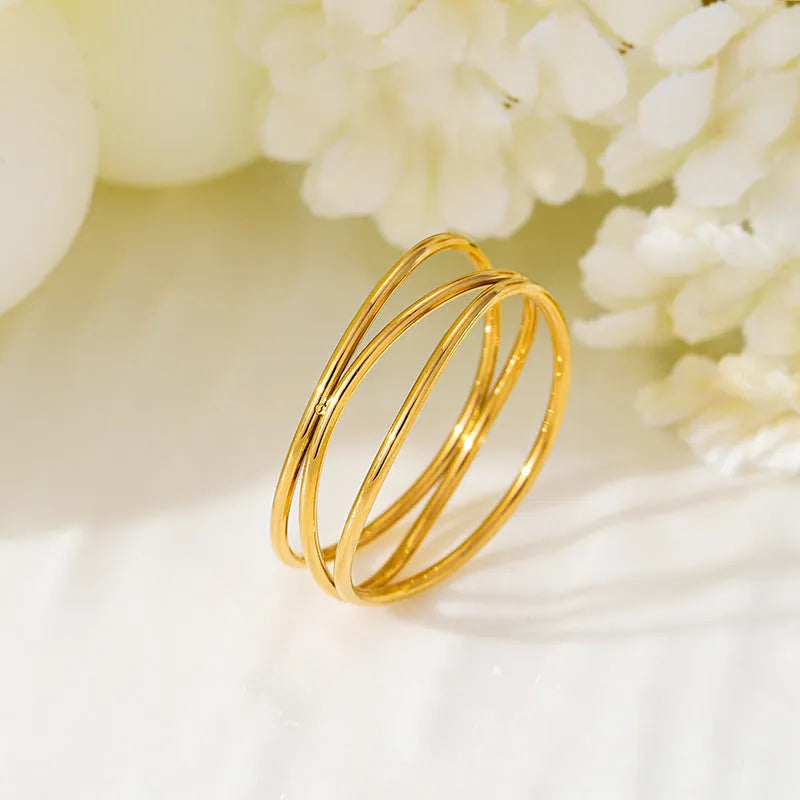 Women's geometric line ring with three-layer coil design in gold colour